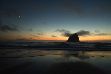 Sunset in Pacific City, Oregon, at Cape Kiwanda, with Chief Kiawanda, or Haystack, Rockの写真素材