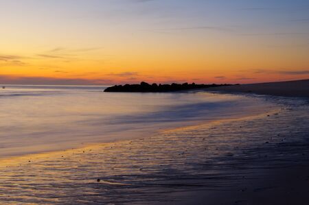 The sun setting over the ocean.