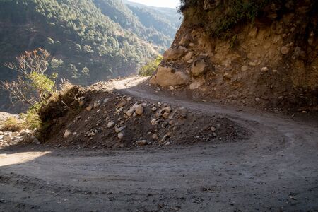 A winding dirt road going through the mountains.の写真素材