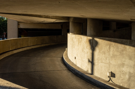 The sloping entrance of a concrete parking garage in the city.のeditorial素材