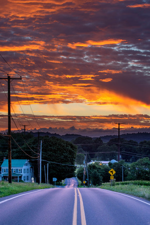 A beautiful orange sunset reflecting on the road.の写真素材