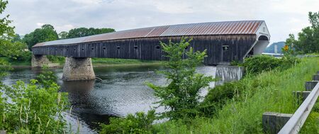The historic Cornish Windsor Covered Bridge over the river.