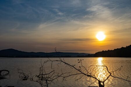 The sun setting over a lake in beautiful colors.の写真素材