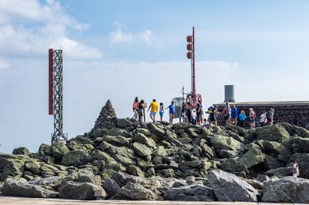 Conway, New Hampshire - July 4 2019: A line of tourists waiting to taking selfies on the summit of Mount Washington in Conway, New Hampshire on July 4, 2019.のeditorial素材