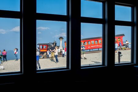 Conway, New Hampshire - July 4, 2019: Looking through some windows at tourists on Mount Washington and the steam engine at Conway, New Hampshire on July 4, 2019.のeditorial素材