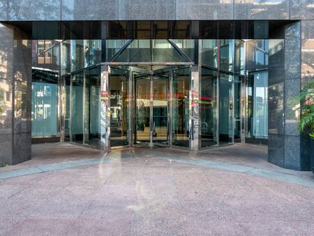 Some glass entrance doors to a large office building.