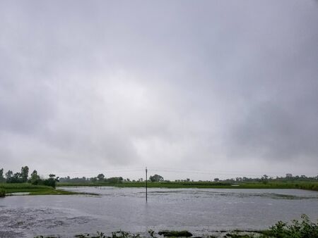 The flooded landscape of the Indian countryside during the monsoon season.