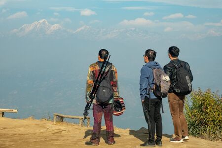 Kathmandu, Nepal - December 19, 2019: Three Chinese tourists gazing at the Himalaya Mountains in Nepal.のeditorial素材