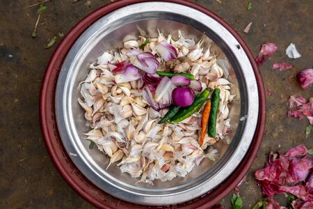 Some Garlic, Onions and Peppers in a Dish ready to be put in the food.の写真素材
