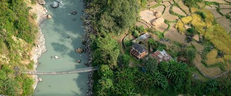 A small farm in the Nepal jungle as seen from the air.