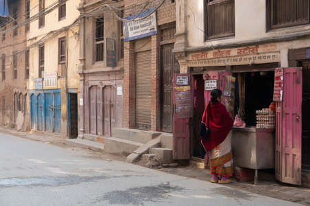 Kathmandu, Nepal - January 14, 2020: A Woman Purchasing Meat at a Meat Shop in Kathmandu, Nepal.のeditorial素材