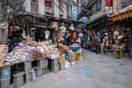 Kathmandu, Nepal - December 31, 2019: Many small shops with lots of food items and other goods just...