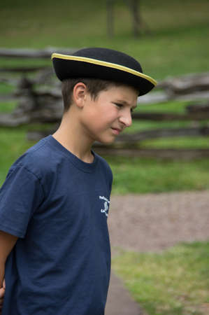 Philadelphia, Pennsylvania - August 30, 2014: A young caucasian boy staring at the ground in the...