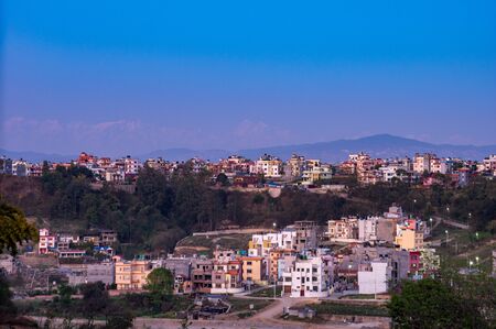 A City Under the Evening Sunset and a Background of the Himalaya Mountain Range in Nepal.の写真素材