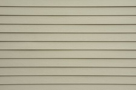 A background wall of tan shiplap siding.の写真素材