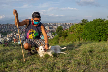 Kathmandu, Nepal - May 30, 2020: A man and his pet dog enjoying time in the public park in Kathmandu, Nepal during the time of lockdown.のeditorial素材