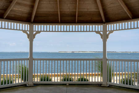 A gazebo by the side of the ocean.の写真素材