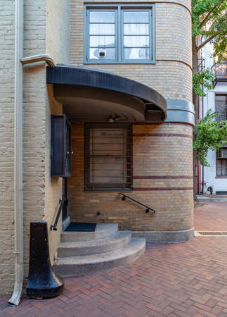 A corner entrance into a building with steps going up to it.