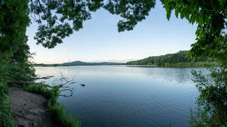 The beauty of a lake in the wilderness in the evening light in the summer time.