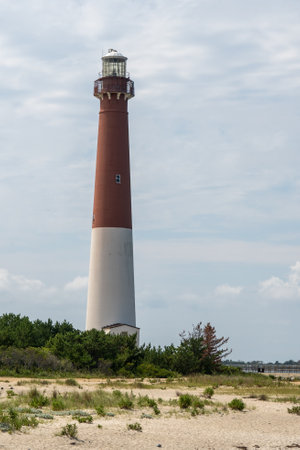 A view of the majestic Barnegat Lighthouse on the shore.の写真素材