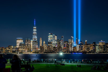 New York, New York - September 11, 2020: A view of the memorial lights rising above the lower Manhattan Island cityscape from Liberty Park.のeditorial素材