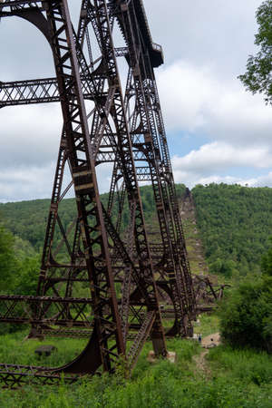 The Kinzua Bridge and the wreckage on the valley floor under cloudy skies.の写真素材