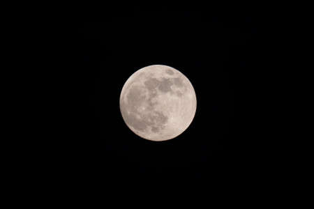 The light of the full moon in the night sky.の写真素材