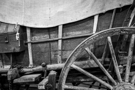 An abstract photo of a wheel and wagon box of an old covered wagon.の写真素材
