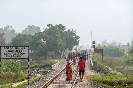 Janakpur, Nepal - October 22, 2021: AA group of school children walking on a railway track in...