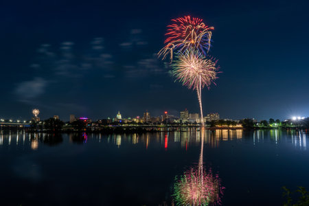 Harrisburg, Pennsylvania - July 4, 2022: A view of the July 4th fireworks over the city of Harrisburg with them reflecting in the Susquehanna River.のeditorial素材