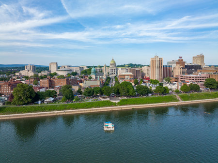 Harrisburg, Pennsylvania - July 4, 2022: An aerial view of the city of Harrisburg looking down main street directly at the capital building with crowds of people aloing the water front.のeditorial素材