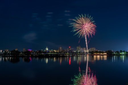 Harrisburg, Pennsylvania - July 4, 2022: A view of the July 4th fireworks over the city of Harrisburg with them reflecting in the Susquehanna River.のeditorial素材