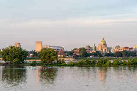 The city of Harrisburg, Pennsylvania skyline partially hidden behind the trees on a small island in...