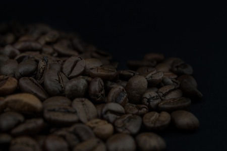 Roasted coffee beans on black background.の写真素材