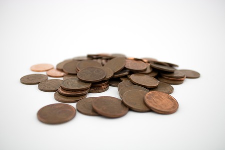 Bronze coins on white background. Coins of five euro cents. Savings.の写真素材