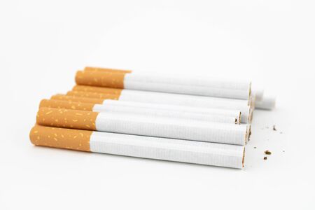 Several cigars on white background. Filtered cigarettes. The tobacco can cause numerous damages to...