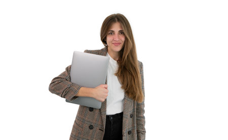 Business woman in suit holding her laptop with her hand, isolated on white background.の写真素材