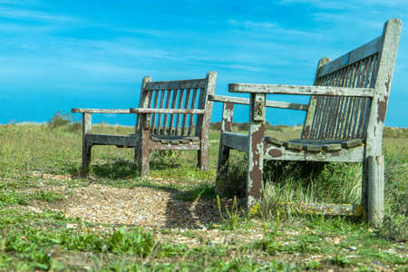 Well worn paint on these two benches facing the beach