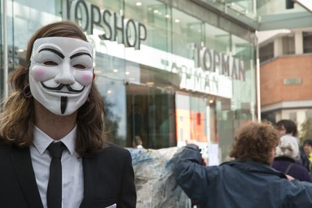 An Occupy Exeter activist wearing a Guy Fawkes mask outside the Exeter branche of Topshopのeditorial素材