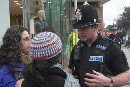 Devon & Corwall police officers confonts two Occupy Exeter activists during their direct action...