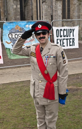 Stuart Crewes, aka Genral Assembly saluted in front of the temporary fencing surrounding the area that was the Occupy Exeter Camp. のeditorial素材