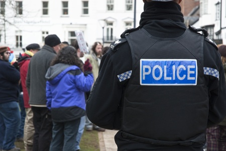 A Devon & Corwall policeman watches the Occupy Exeter activists as they celebrate their achievments...