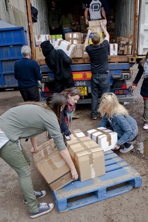 Volunteer from BookCycle loads a box into the container that is taking donated book to Ghanaのeditorial素材