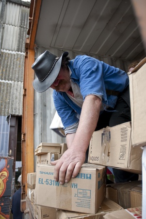 Volunteers from BookCycle stack boxes inside the container that is taking donated books to Ghana