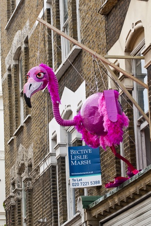 A giant flamingo puppet hanging from an apartment window at the Notting Hill Carnival on August 30, 2010 in Notting Hill, London. のeditorial素材