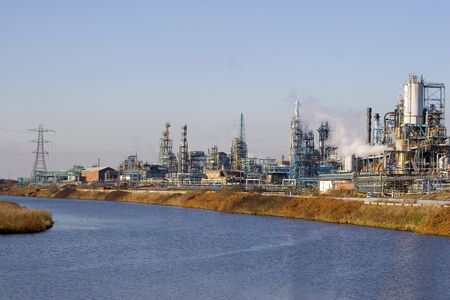 A view of a chemical factory by a riverの写真素材