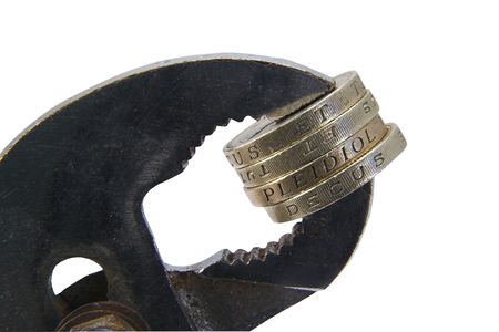 Coins held in a viceの写真素材