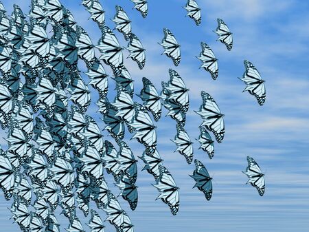A cloud of butterflies flying through a blue skyの写真素材