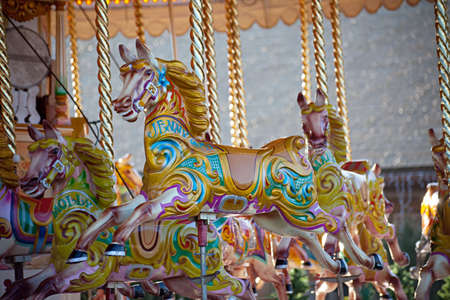 Colorful wooden horses on a carousel rideの写真素材