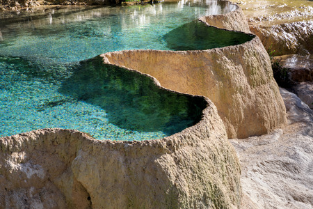 Pools of colorful blue water in Huanglong Scenic Area in Sichuan Province, China. Beautiful and exotic natural geological landforms caused by erosion over time, Yellow Dragon Chinese natural terracesの写真素材